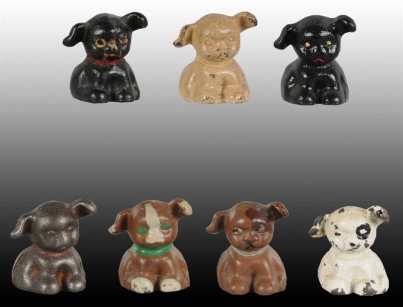 LOT OF 7: PUPPO DOG CAST IRON PAPERWEIGHTS.       