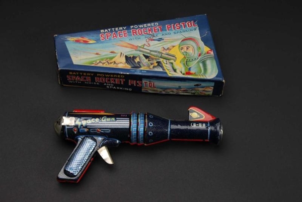 TIN SPACE ROCKET PISTOL BATTERY-OPERATED TOY.     