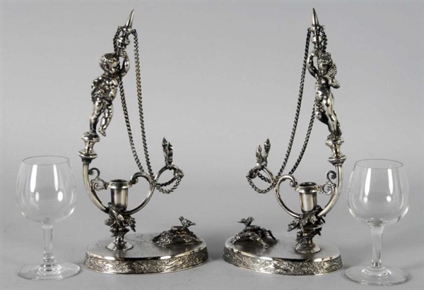 PAIR OF SILVER PLATED FIGURAL WINE GLASS HOLDERS. 