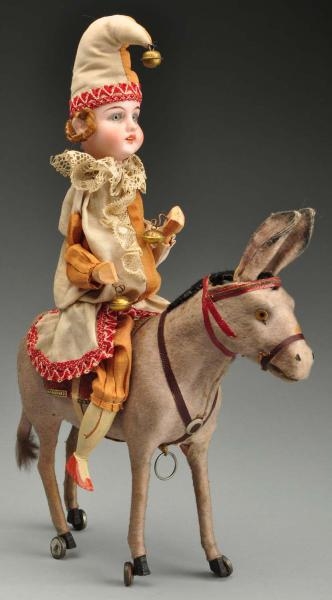 BISQUE HEAD CLOWN ON DONKEY PULL TOY.             