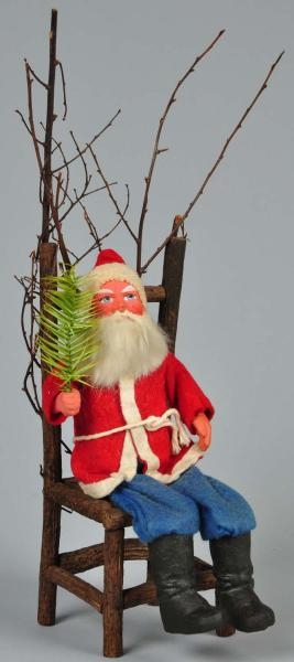 LARGE SANTA SITTING ON EARLY PUTZ CHAIR.          