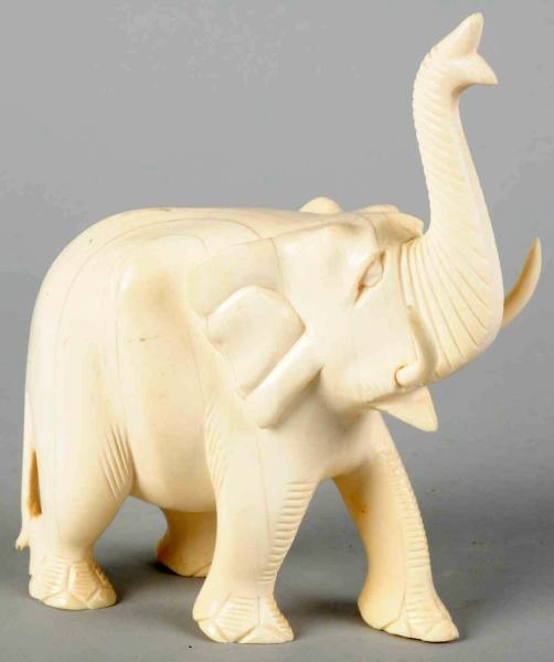 CARVED IVORY ELEPHANT WITH TRUNK UP.              