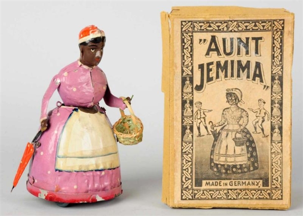 HAND-PAINTED TIN AUNT JEMIMA WIND-UP TOY.         