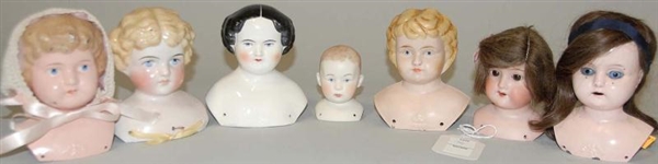 SEVEN DOLL HEADS.                                 