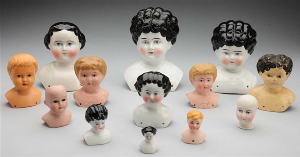 LOT OF 13: DOLL HEADS.                            