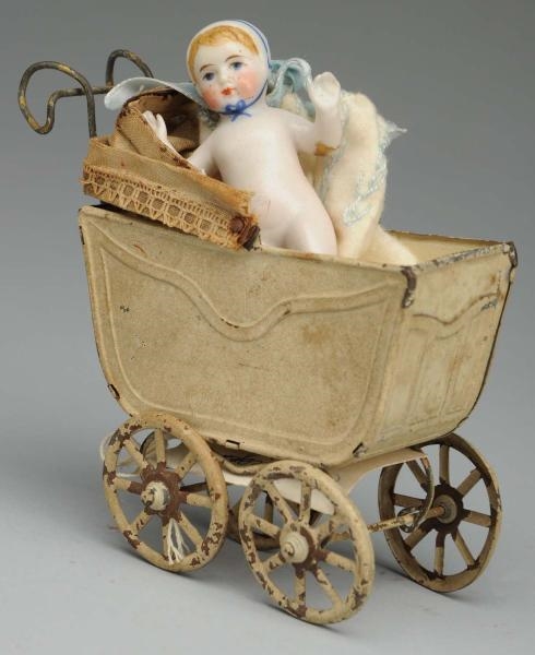 EARLY BABY IN TIN CARRIAGE.                       