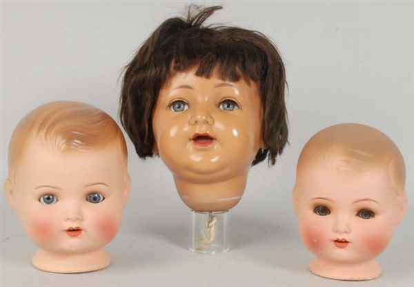 LOT OF 3: CHARACTER BABY DOLL HEADS.              