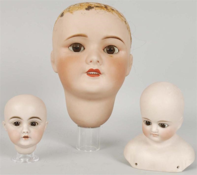 LOT OF 3: ANTIQUE BISQUE DOLL HEADS.              