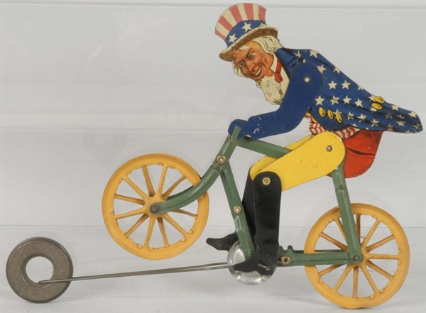 EARLY TIN LITHO UNCLE SAM BICYCLIST TOY.          