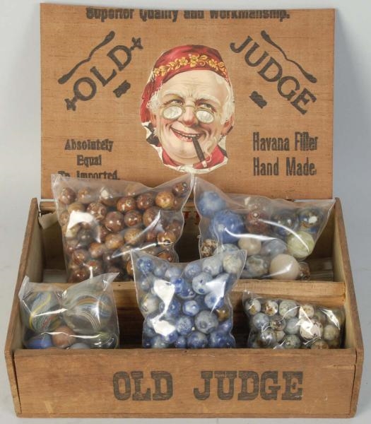 LARGE LOT OF MARBLES IN OLD JUDGE CIGAR BOX.      