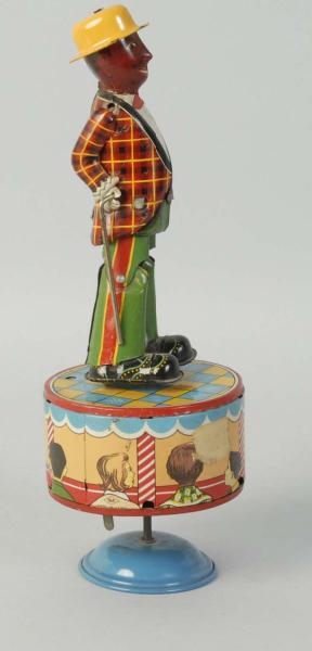 JAPANESE TIN WIND-UP DANCING SAND TOY.            