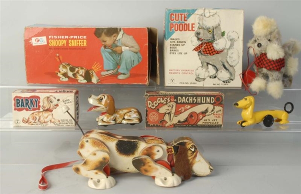 LOT OF 4: BOXED MECHANICAL TOY DOGS.              