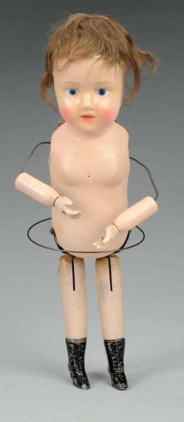 WOODEN WIND-UP DOLL.                              