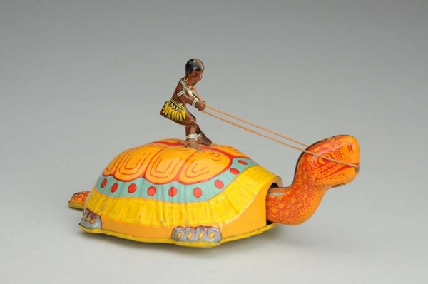CHEIN TIN LITHO WIND-UP NATIVE ON TURTLE TOY.     