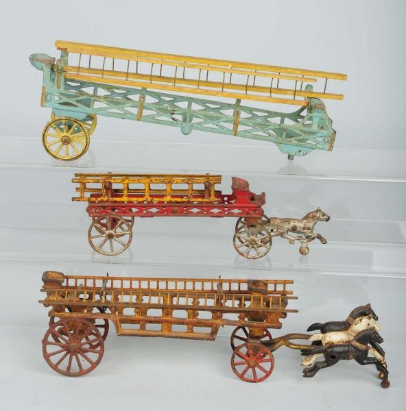 LOT OF 3: CAST IRON HORSE DRAWN LADDER WAGONS.    