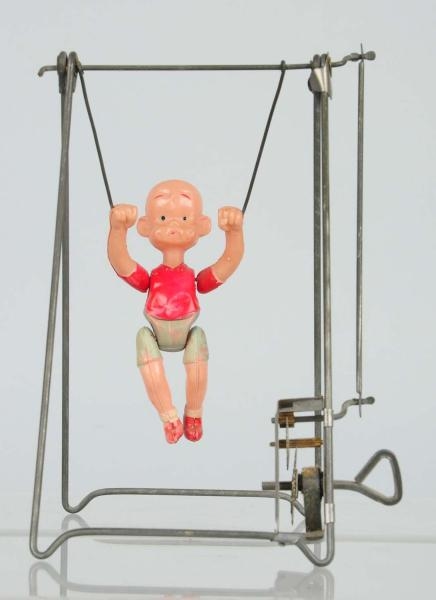 CELLULOID HENRY TRAPEZE TOY.                      