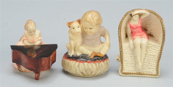 LOT OF 3: CELLULOID FIGURAL SEWING TAPE MEASURES. 