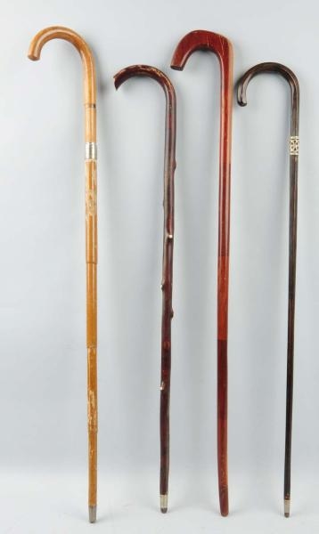 LOT OF 4: WALKING CANES.                          