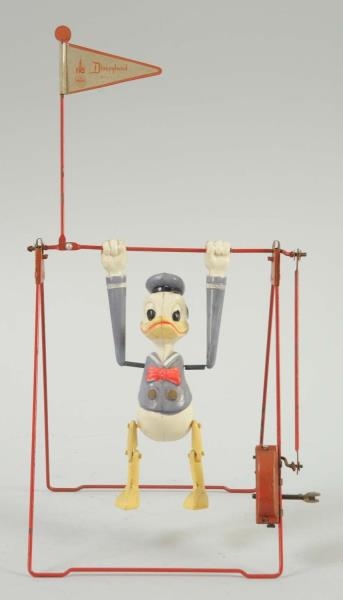 LINEMAR TIN WIND-UP DONALD DUCK TRAPEZE.          