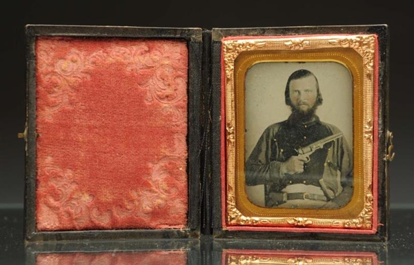 AMBROTYPE OF A SOLDIER HOLDING GUN.               