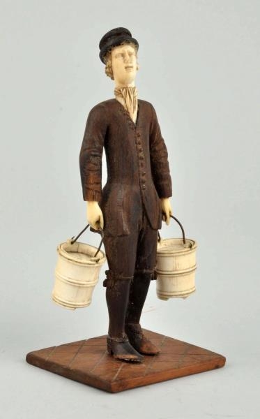 WOOD AND BONE FIGURE OF A MAN WITH BUCKETS.       