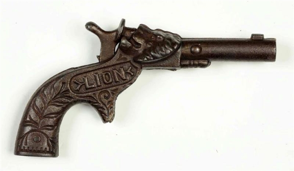 CAST IRON LION CAP GUN.                           