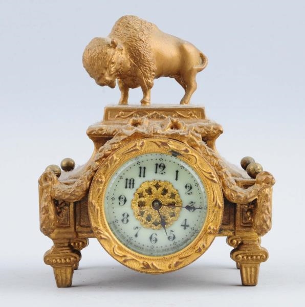 SMALL NEW HAVEN CLOCK WITH A BRONZE BUFFALO.      
