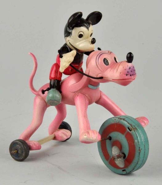 DISNEY CELLULOID WIND-UP MICKEY RIDING PLUTO TOY. 