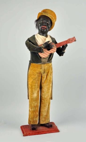 BLACK AMERICANA WIND-UP DOLL WITH GUITAR.         