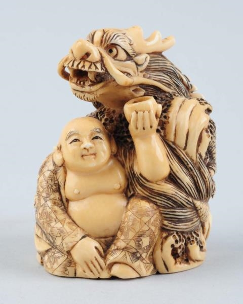 CARVED DRAGON IN IVORY.                           