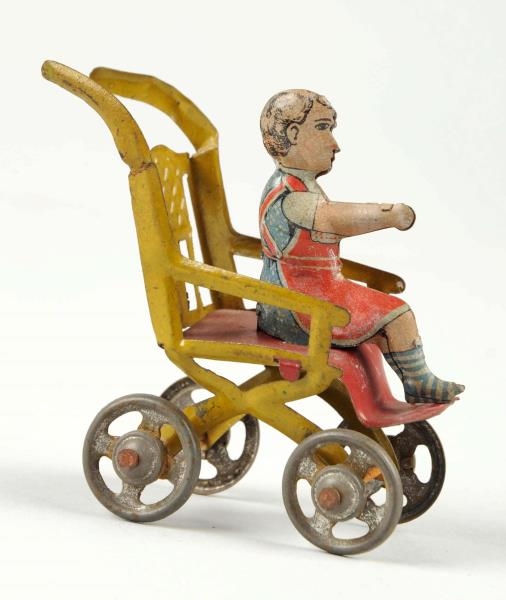 GERMAN TIN LITHO CHILD IN HIGHCHAIR PENNY TOY.    