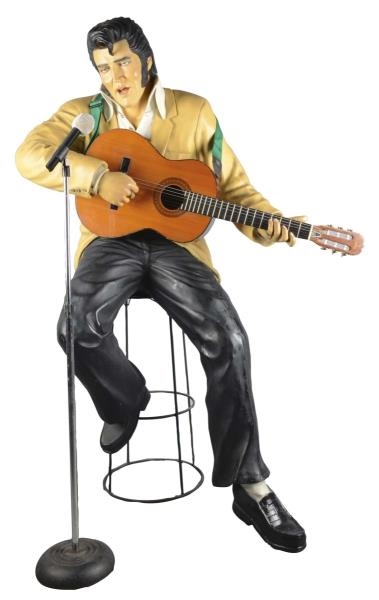 ELVIS PLAYING GUITAR SEATED FIGURAL STATUE        
