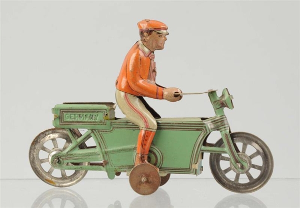 RARE GERMAN TIN LITHO MOTORCYCLE PENNY TOY.       