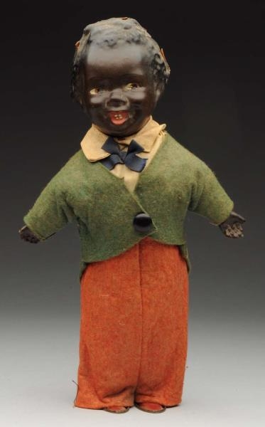13" BLACK COMPOSITION HEAD WIND UP DOLL.          