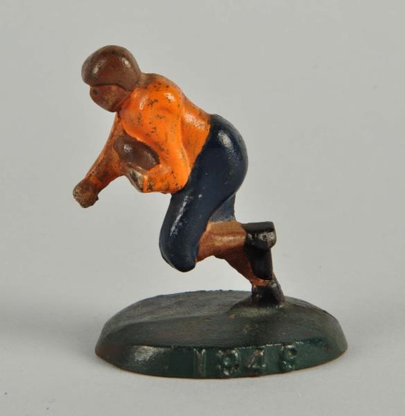 CAST IRON FOOTBALL PLAYER WITH BALL PAPERWEIGHT.  