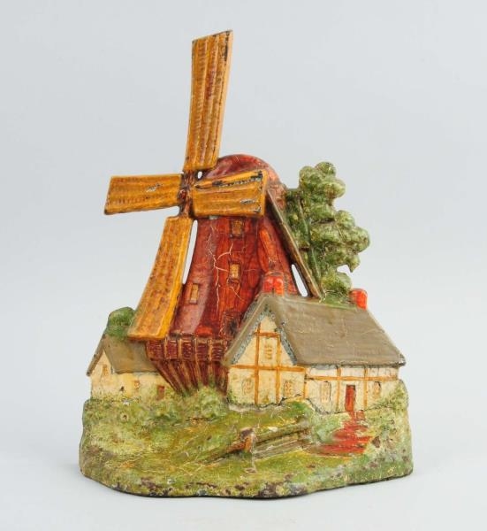 CAST IRON WINDMILL WITH COTTAGES DOORSTOP.        