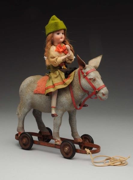DOLL ON HORSE PULL TOY.                           