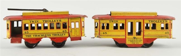PAIR OF STRAUSS TIN WIND UP TRACKLESS TROLLEYS.   