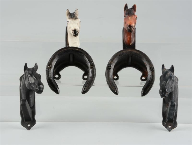LOT OF 4: CAST IRON ASSORTED HORSE BRIDLE RACKS.  