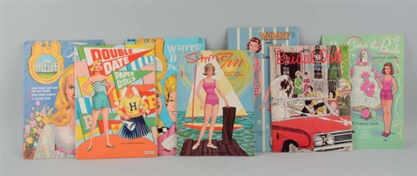 LOT OF 7: ASSORTED VINTAGE UNCUT PAPER DOLL BOOKS.