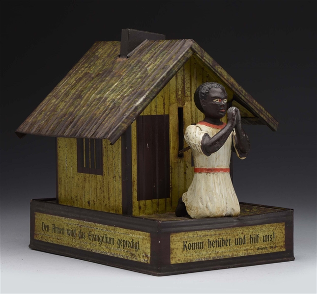 TIN ALMS BOX WITH AFRICAN FIGURE BANK.