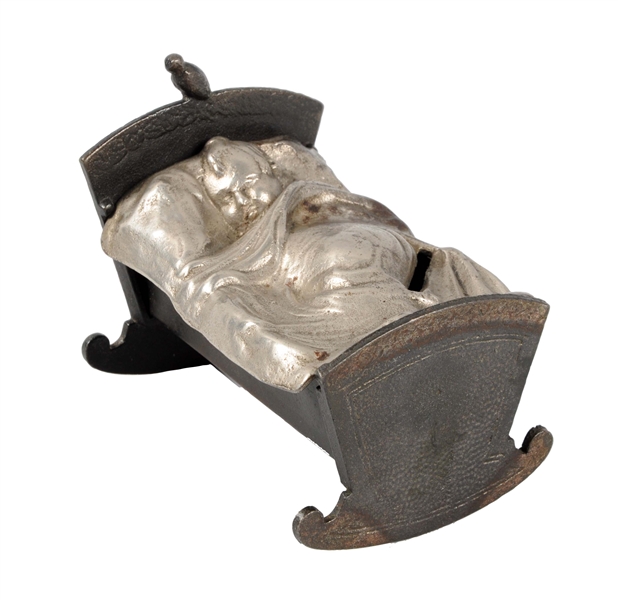 CAST IRON BABY IN CRADLE STILL BANK.