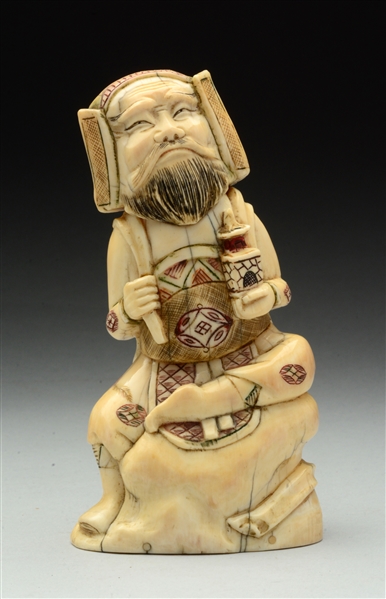 CARVED IVORY SEATED MAN.
