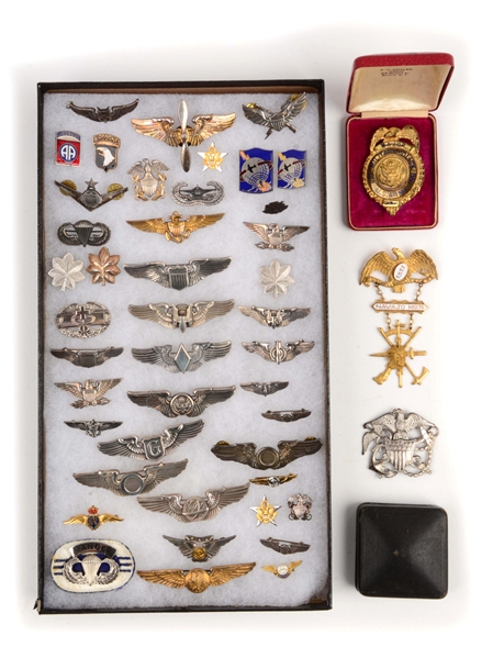 LOT OF 46: ASSORTED U.S. MILITARY BADGES AND PINS.