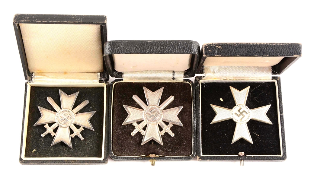 LOT OF 3: WWII CASED 1ST CLASS WAR MERIT MEDALS.