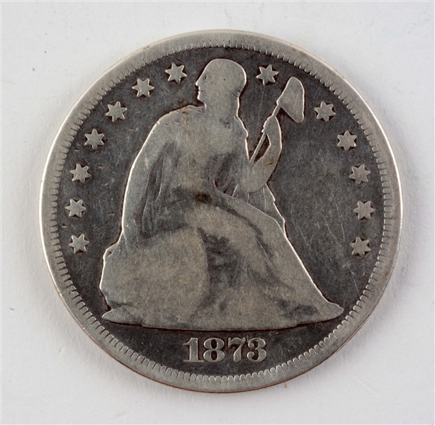 1873 SEATED SILVER DOLLAR.