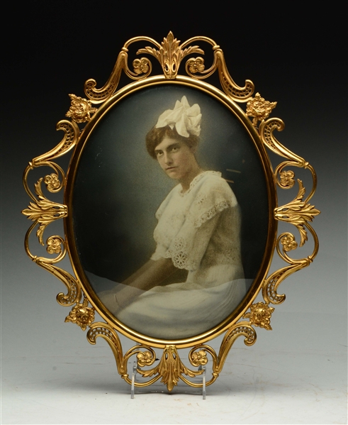 A VICTORIAN BRASS OVAL FRAME W/ YOUNG LADY IN A LACE DRESS.