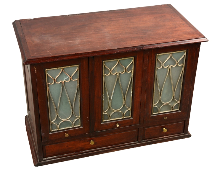 MAHOGANY DENTAL CABINET WITH LEADED GLASS FRONT DOORS.