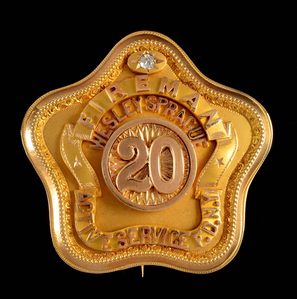 14K GOLD 20 YEAR ACTIVE SERVICE BADGE TO A NEW YORK CITY FIREMAN.