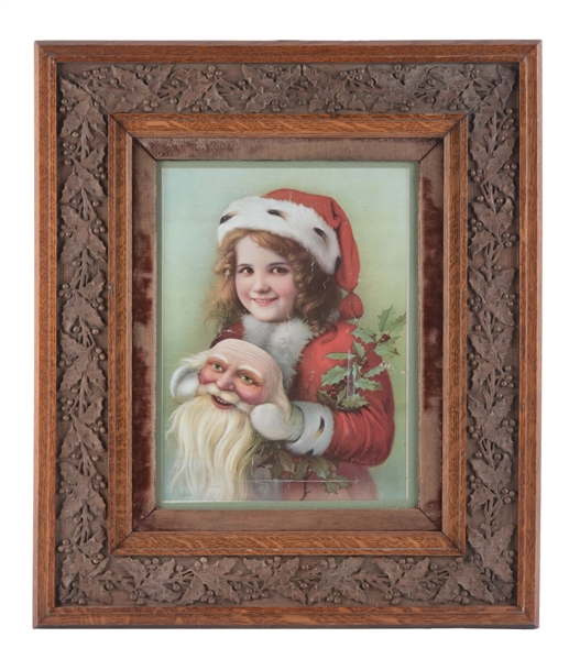 PRINT OF A GIRL IN SNOW CLOTHES HOLDING A SANTA MASK IN HOLLY FRAME.